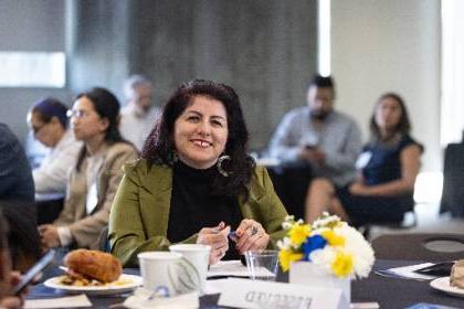 Dr. Nancy Gutierrez seated at a table during the Celebration of Education event